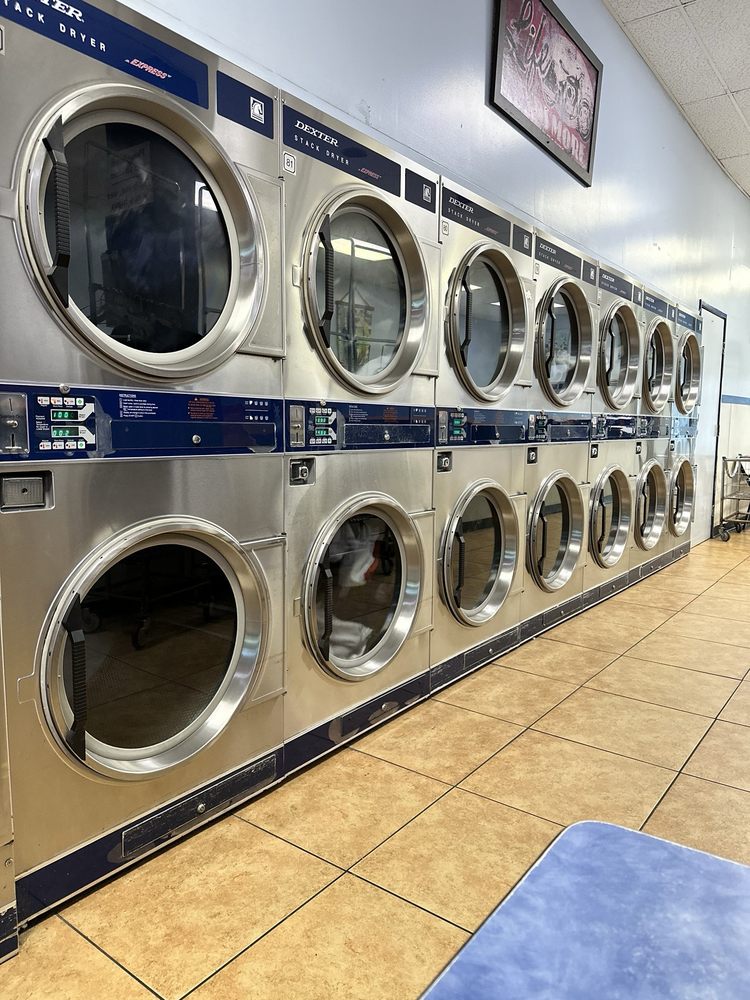 Row of freshly laundered shirts hanging in a clean laundromat