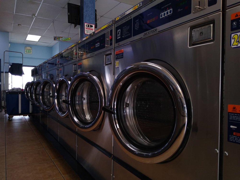Interior of a spacious laundromat facility with washing machines